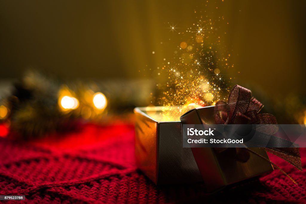 Christmas gift with gold particles magic lights Christmas gift with gold particles magic lights. Christmas Stock Photo