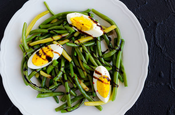 istock Warm salad with cooked green beans and boiled eggs 879530128
