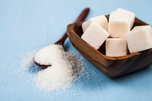 istock Sugar in a wooden bowl and a spoon 879535090
