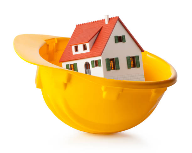 istock Miniature model house in yellow hardhat 879538042