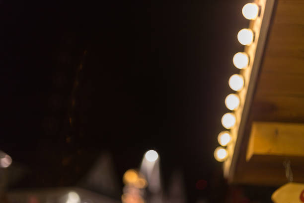 Blurred bokeh christmas tree on a marketplace in november south german historical city near munich and stuttgart