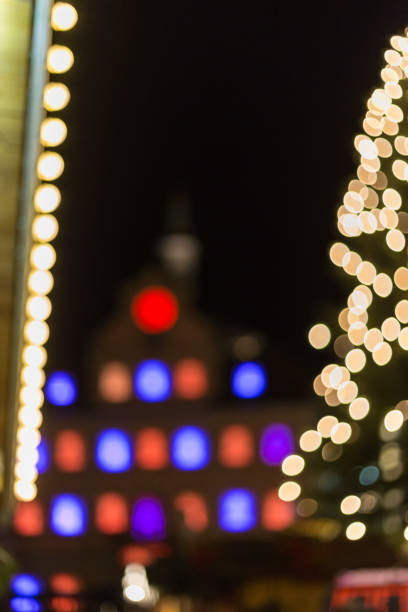 istock Blurred bokeh christmas tree on a marketplace 879543046