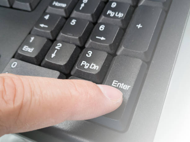 istock Male finger is pushing the enter button 879545750
