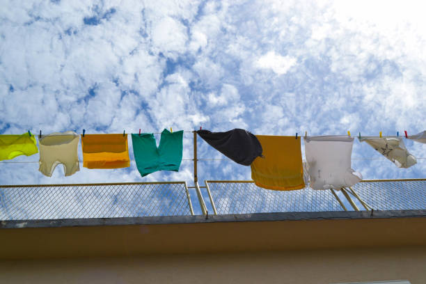 istock Colorful clean laundry hanging under the sky and white clouds 879550834