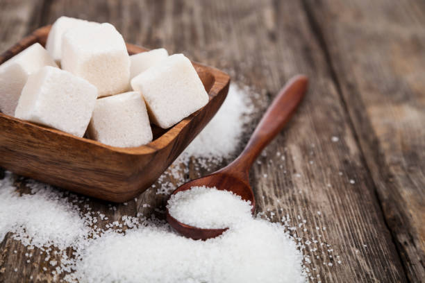 Bowl with sugar and a wooden spoon