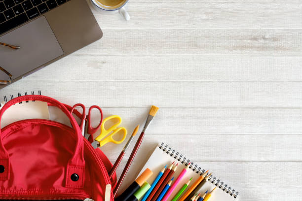 istock School backpack and school supplies on white wood table background. Back to school concept. 879573906