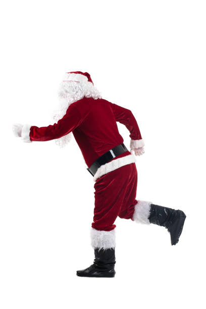 istock Happy traditional Santa Claus running isolated on white background. 879579448
