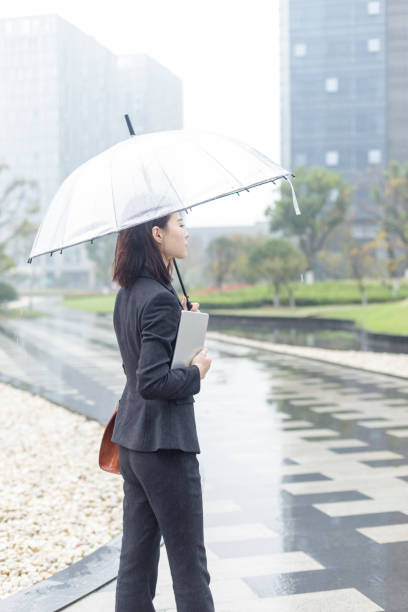 istock Businesswoman holding digital tablet under umbrella 879579744