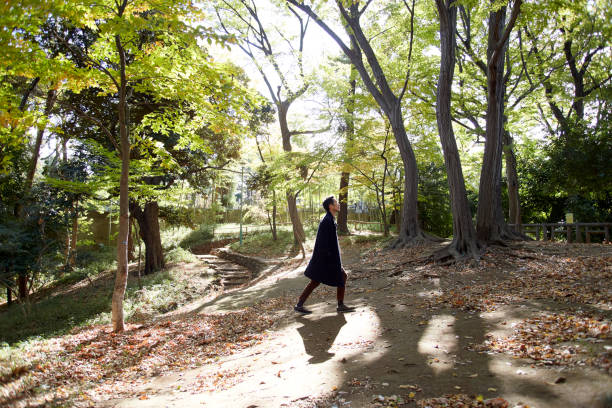 istock young man walking through the woods lit with sunshine 879586018