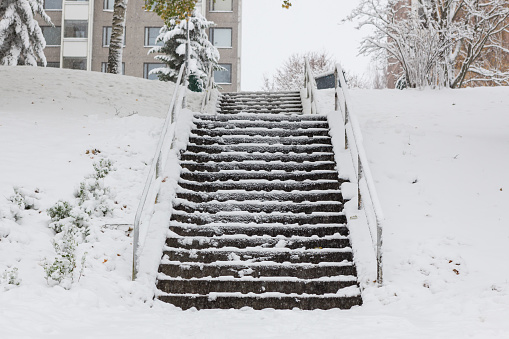 Slippery stairs after first snow in city park