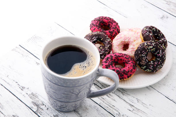 istock donuts and coffee for a sweet breakfast on wooden background 879588180