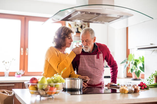 istock Senior couple preparing food in the kitchen. 879588388