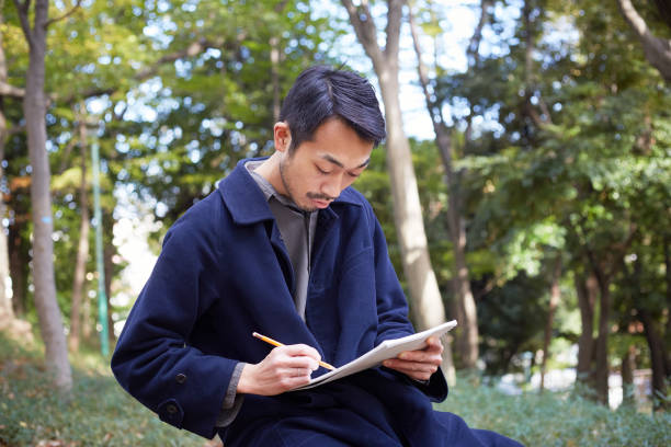 istock young man sketching in the woods lit with sunshine 879588394