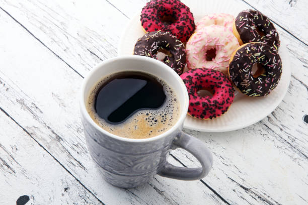 istock donuts and coffee for a sweet breakfast on wooden background 879588444