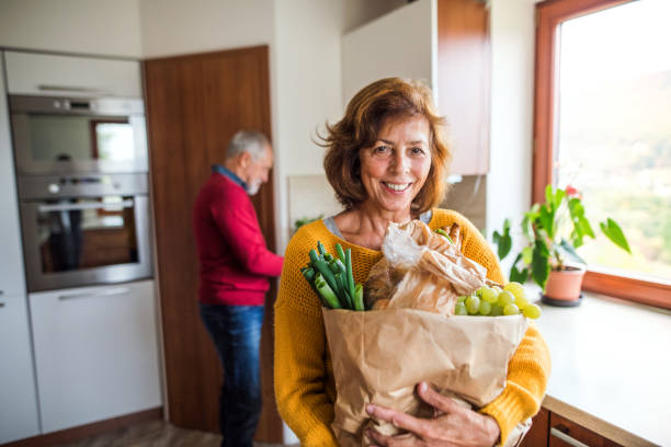 istock Senior couple preparing food in the kitchen. 879588460