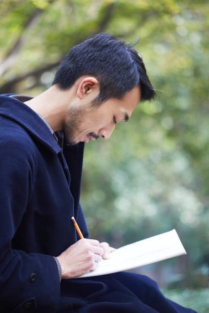 istock young man sketching in the woods lit with sunshine 879588486