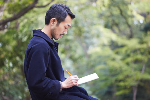 istock young man sketching in the woods lit with sunshine 879588558