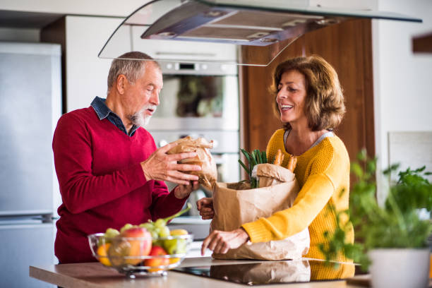 istock Senior couple preparing food in the kitchen. 879588692