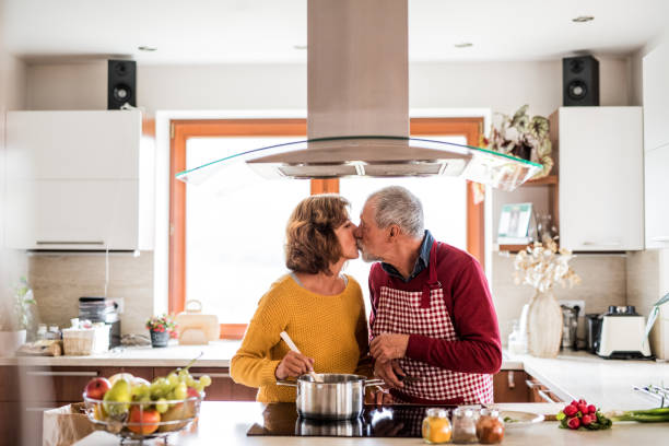 istock Senior couple preparing food in the kitchen. 879588722