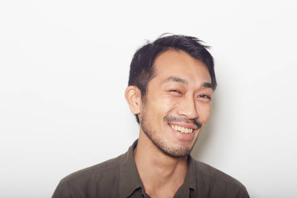 istock closeup face of young man with a beard smiling 879588780