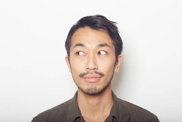 istock closeup face of young man with a beard looking away 879588814
