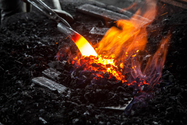 istock Orange light from charcoal stove burned to make a knife. 879591052