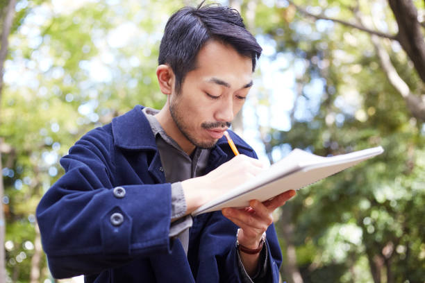 istock young man sketching in the woods lit with sunshine 879591310