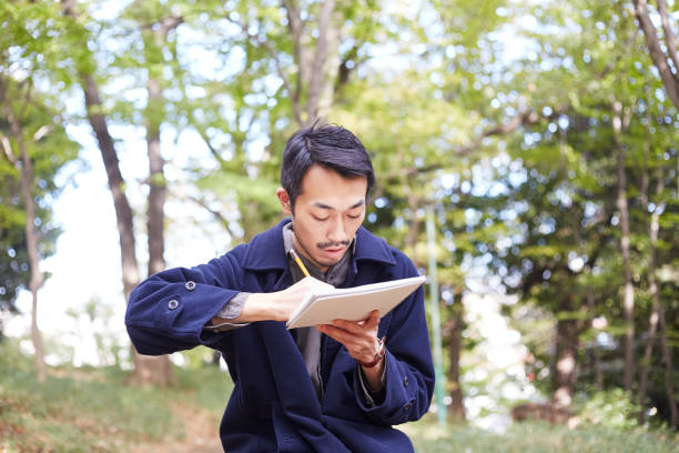 istock young man sketching in the woods lit with sunshine 879591440