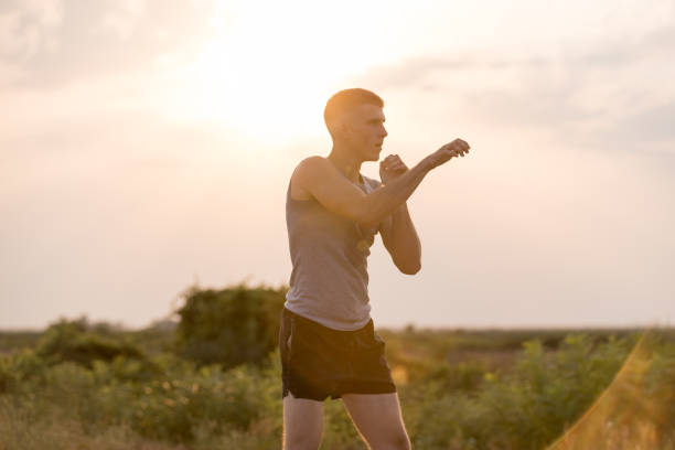 istock Man trainging shadow boxing outdoors 879591522