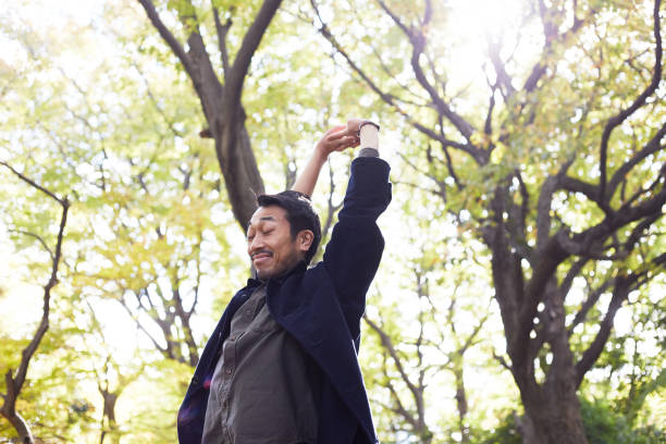 istock young man stretching in the woods lit with sunshine 879591566