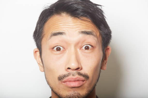 istock closeup shocked face of young man with a beard 879591838