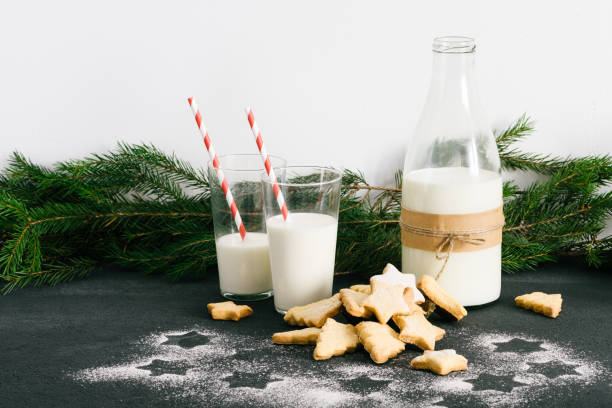 christmas themed homemade cookies and milk on the table - milk milk bottle drinking straw cookie imagens e fotografias de stock