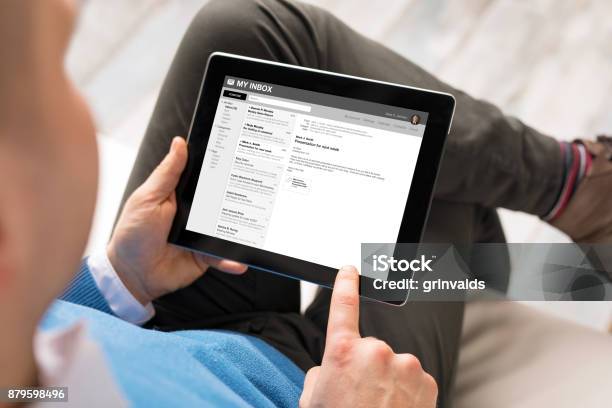 Man Reading Email On Tablet Stock Photo - Download Image Now - E-Mail, Device Screen, Digital Tablet