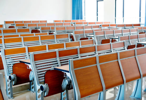 istock Desks and chairs in a lecture hall 879602948