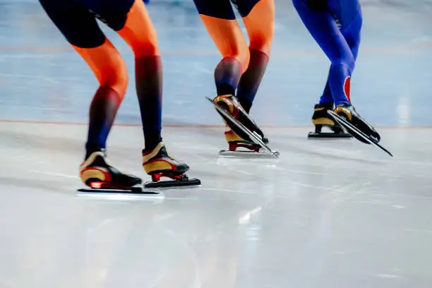 Photo of legs women athletes speed skaters in mass start competition