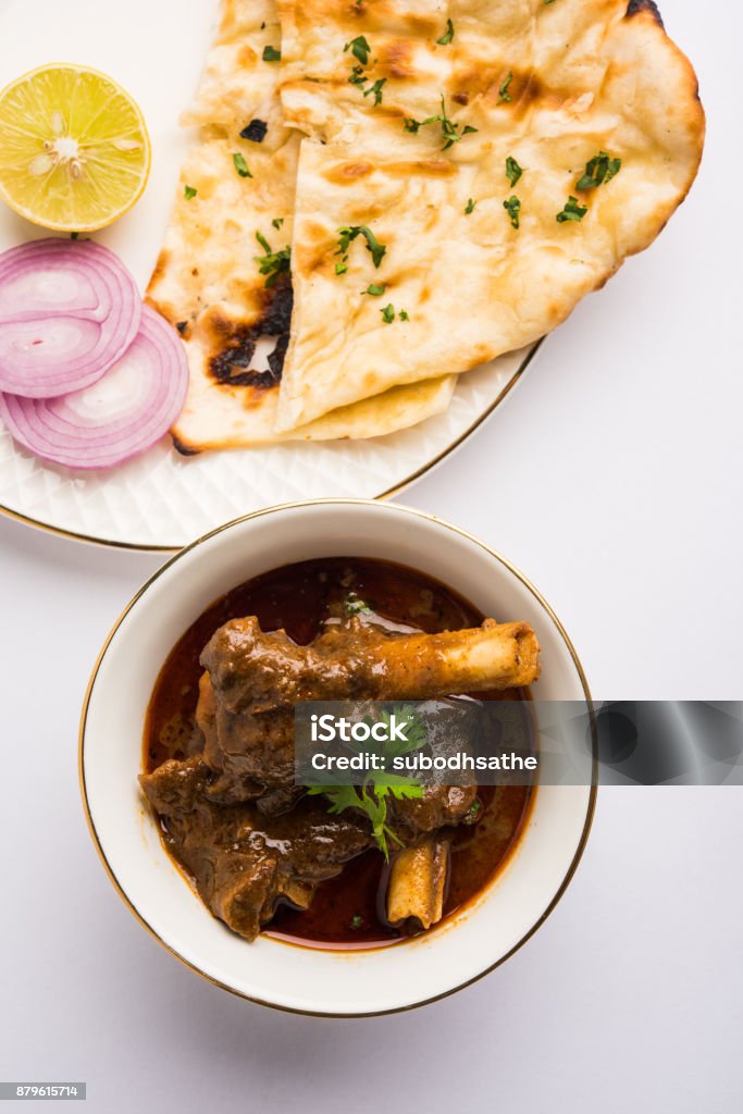 Mutton Curry or Or Masala Gosht or indian lamb rogan josh Mutton Masala Or Masala Gosht or indian lamb rogan josh with some seasoning, served with Naan or Roti, selective focus Curry - Meal Stock Photo