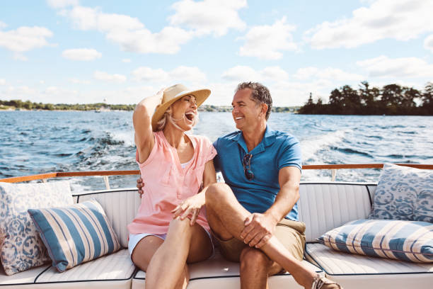 Living happily ever after out on a lake Shot of a mature couple enjoying a relaxing boat ride nautical vessel stock pictures, royalty-free photos & images