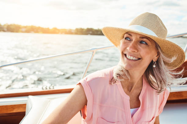 What’s a vacation without a cruise? Shot of a mature woman enjoying a relaxing boat ride wealthy lifestyle stock pictures, royalty-free photos & images