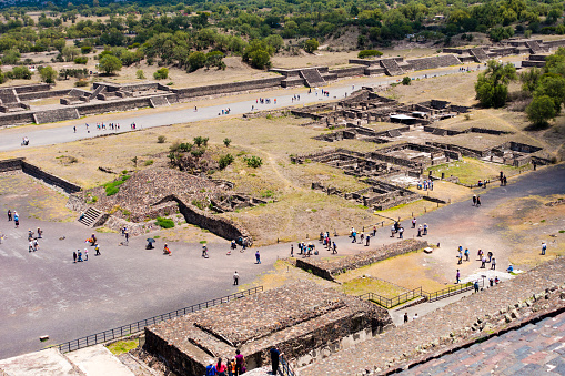 People walking around the ruins at the city of Teotihuacan during a hot summer day. The archaeological site are located in what is now the San Juan Teotihuacán municipality in the State of México, approximately 40 kilometres northeast of Mexico City. The site covers a total surface area of 83 square kilometres and was designated a UNESCO World Heritage Site in 1987. It is the most visited archaeological site in Mexico.