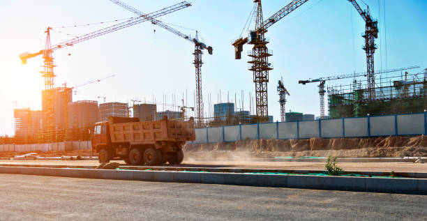 Cranes and truck working on construction site