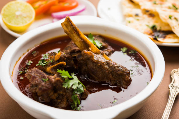 Mutton Curry or Or Masala Gosht or indian lamb rogan josh Mutton Masala Or Masala Gosht or indian lamb rogan josh with some seasoning, served with Naan or Roti, selective focus karahi stock pictures, royalty-free photos & images