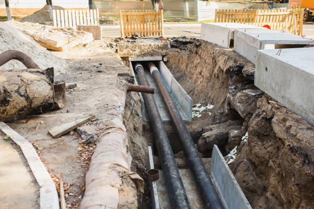 istock Water pipes with insulation lie on the ground. Construction works. 879631738