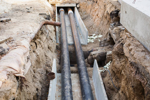 istock Water pipes with insulation lie on the ground. Construction works. 879632054