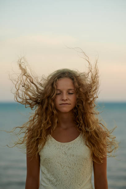 Shot of a carefree young woman with her hair blowing in the wind