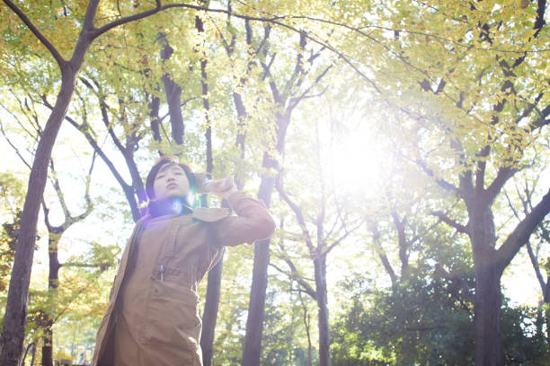 istock a young woman stretching in a forest 879640644