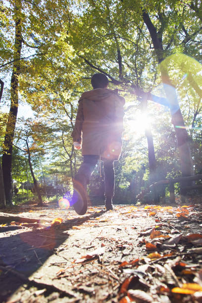 istock a young woman walking in the woods 879641316