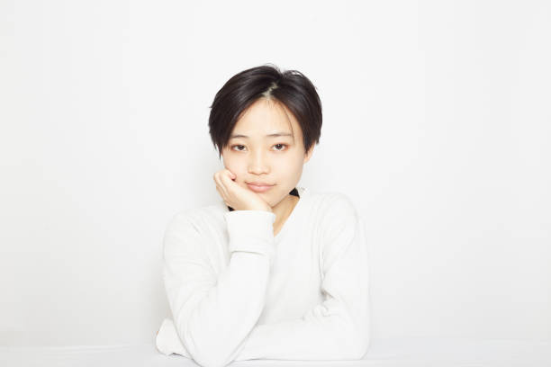 Studio shot photo of a young woman in front of a table