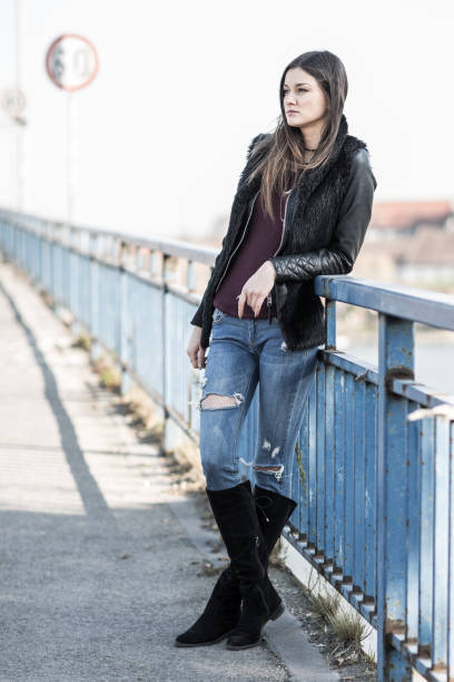 istock Pensive woman day dreaming on the bridge. 879645012