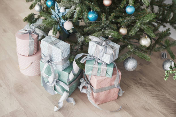 istock Christmas tree with wooden rustic decorations and presents under it in loft interior 879651770