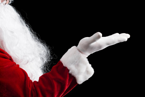istock Santa Claus hand presenting isolated on black background. 879652466